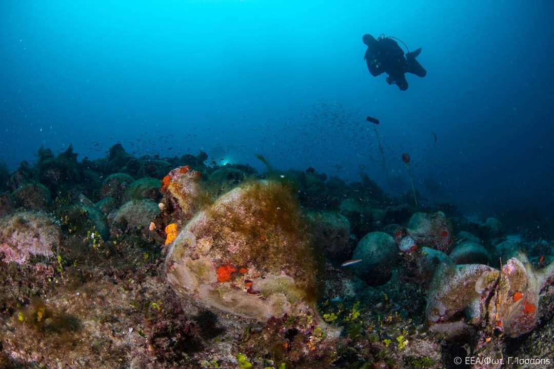 diver approaches an amphorae to Peristera Shipwreck